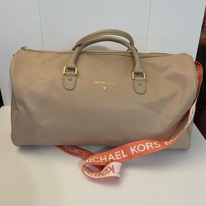 Michael Kors faux leather weekender in blush pink.
